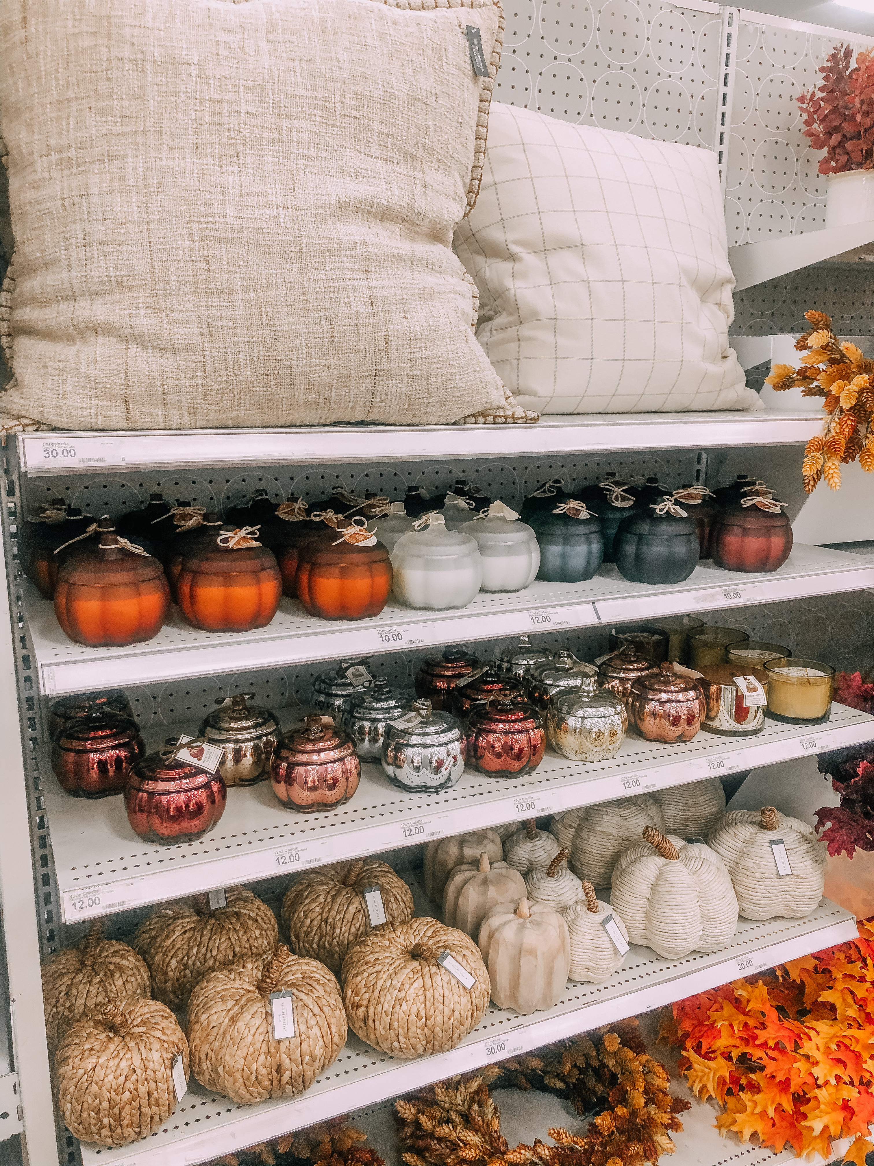 Fall home decor, throw pillows, decorative pumpkins, and fall scented candles.