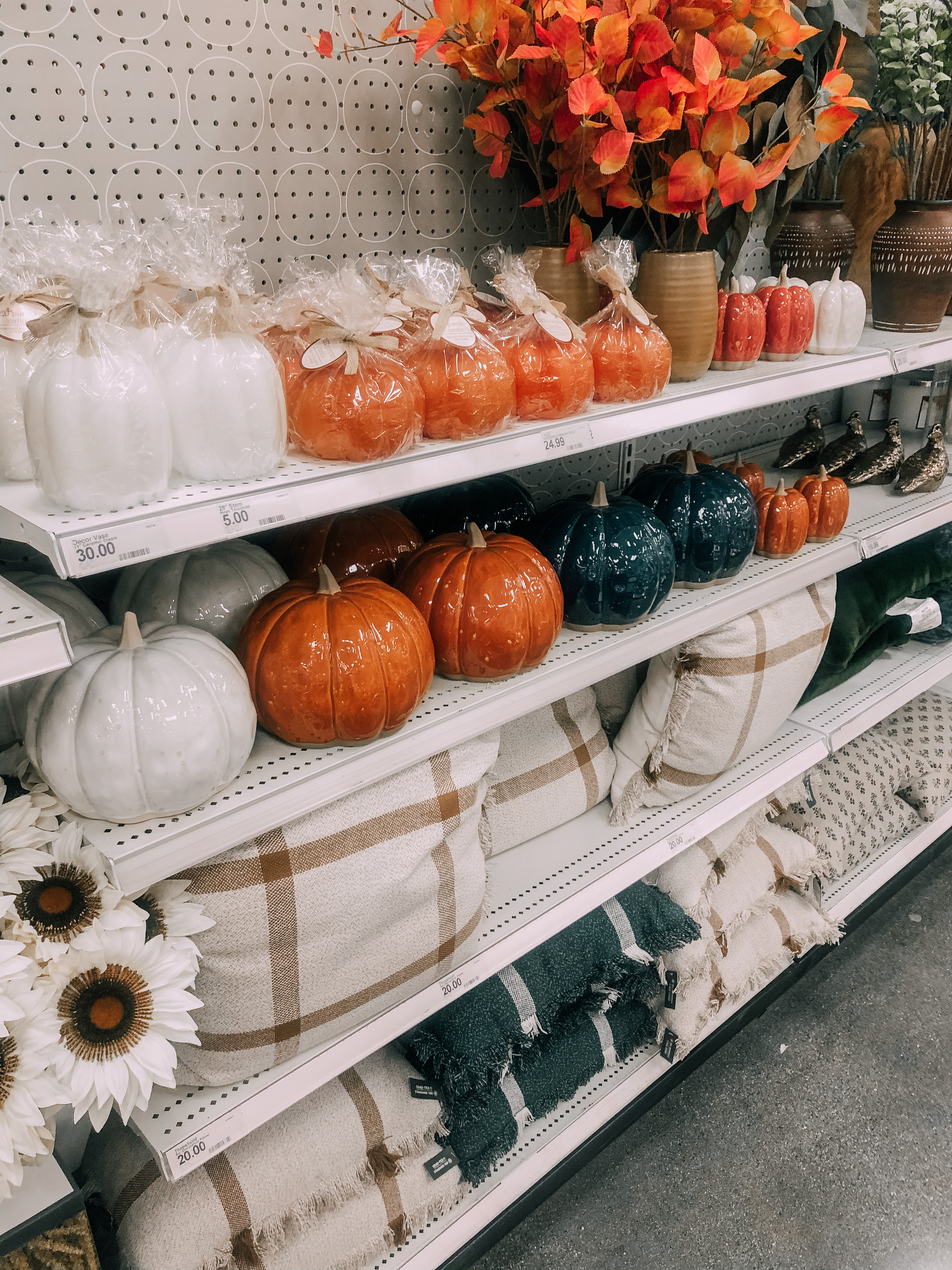 Fall candles, decorative pumpkins, throw pillows for fall.